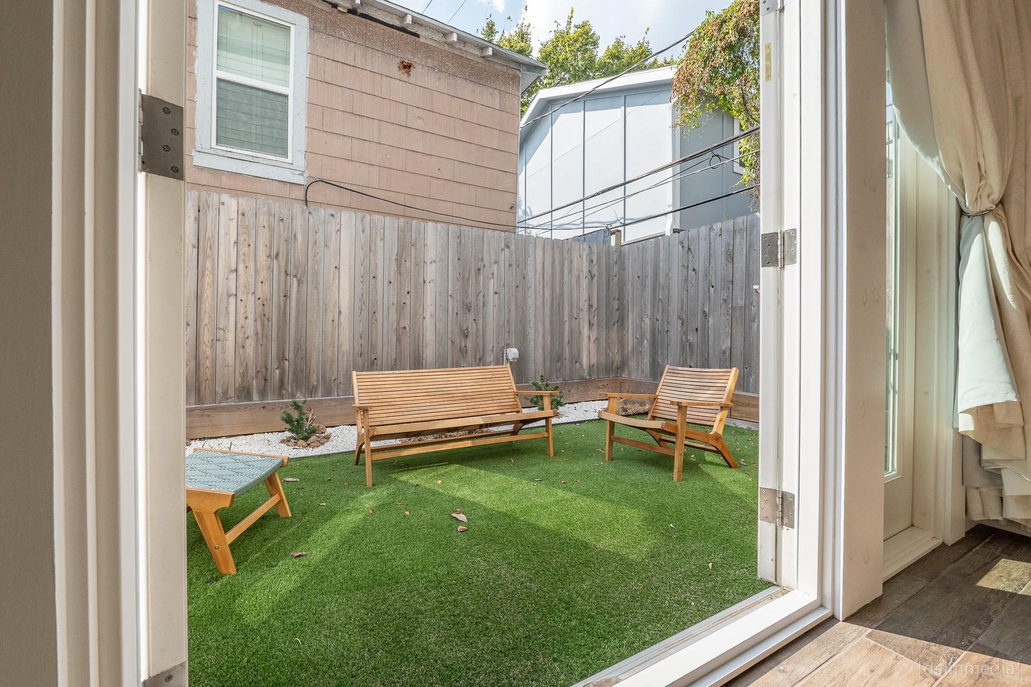 2002 Norfolk Street, Unit A Houston, TX 77098 - Photo 25 of 35 a view of a backyard with chairs and a patio