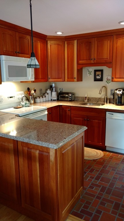 841 Dennison Drive Southbridge, MA 01550 - Photo 11 of 28 a kitchen with stainless steel appliances granite countertop wooden cabinets a sink and dishwasher