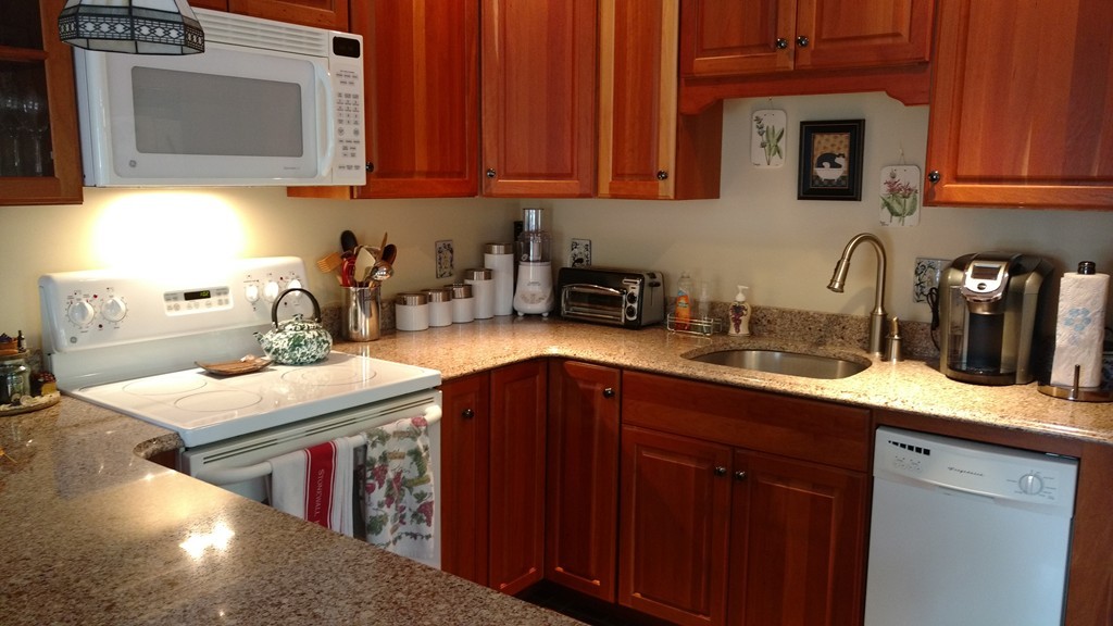 841 Dennison Drive Southbridge, MA 01550 - Photo 10 of 28 a kitchen with stainless steel appliances granite countertop a sink stove and cabinets