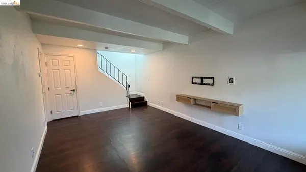 a view of a room with wooden floor and stairs
