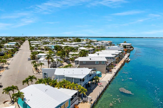 an aerial view of a house with a ocean view