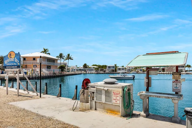 a tennis court with view of palm trees