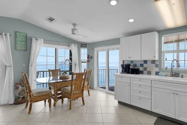 a living room with a couch and a view of kitchen