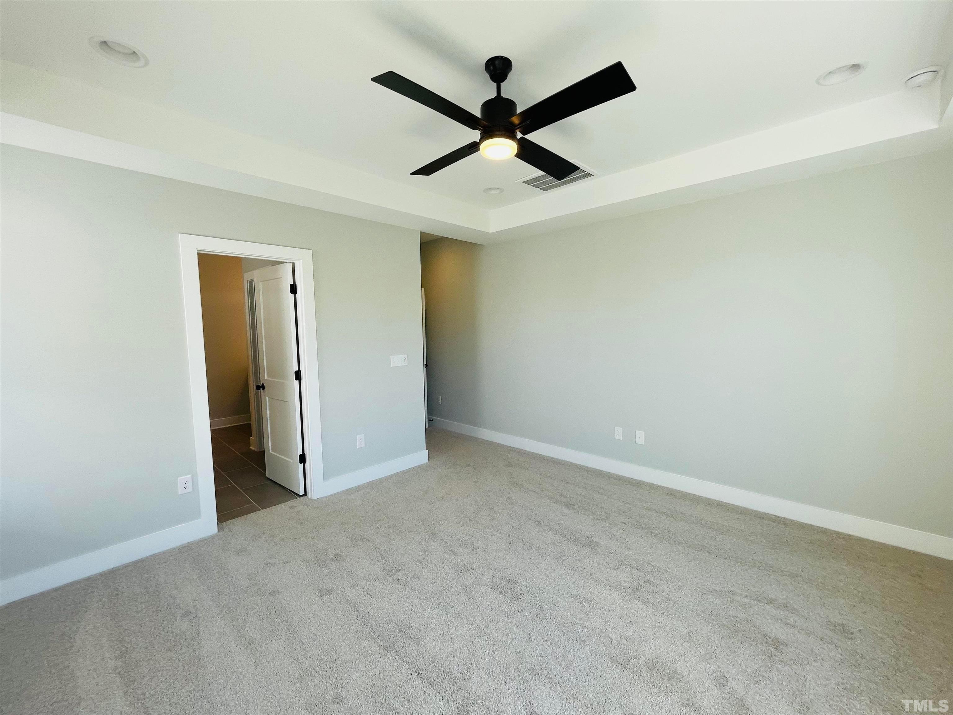 200 East Moore Street Apex, NC 27502 - Photo 11 of 32 an empty room with ceiling fan and a ceiling fan