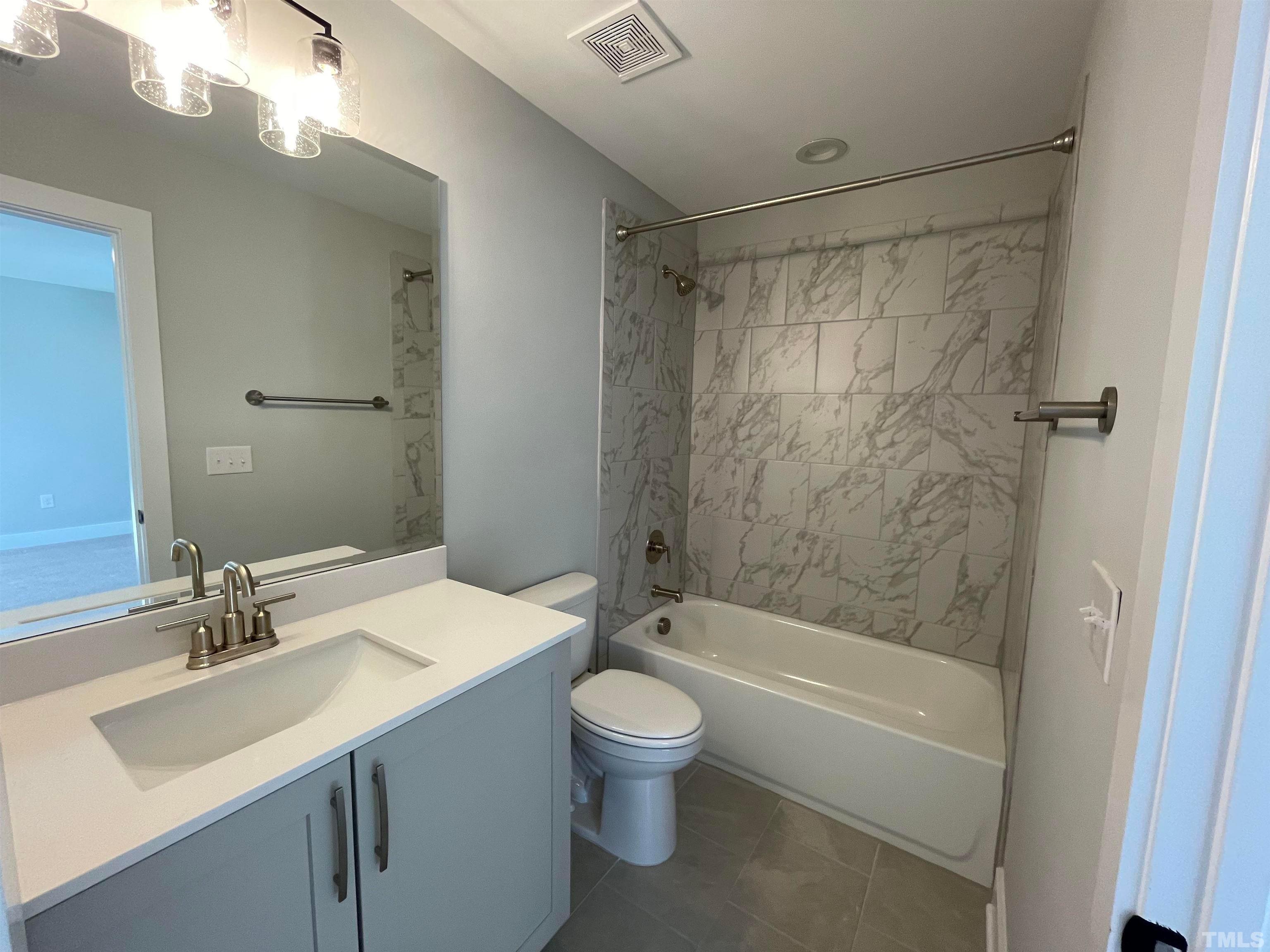 200 East Moore Street Apex, NC 27502 - Photo 19 of 32 a bathroom with a sink toilet and shower