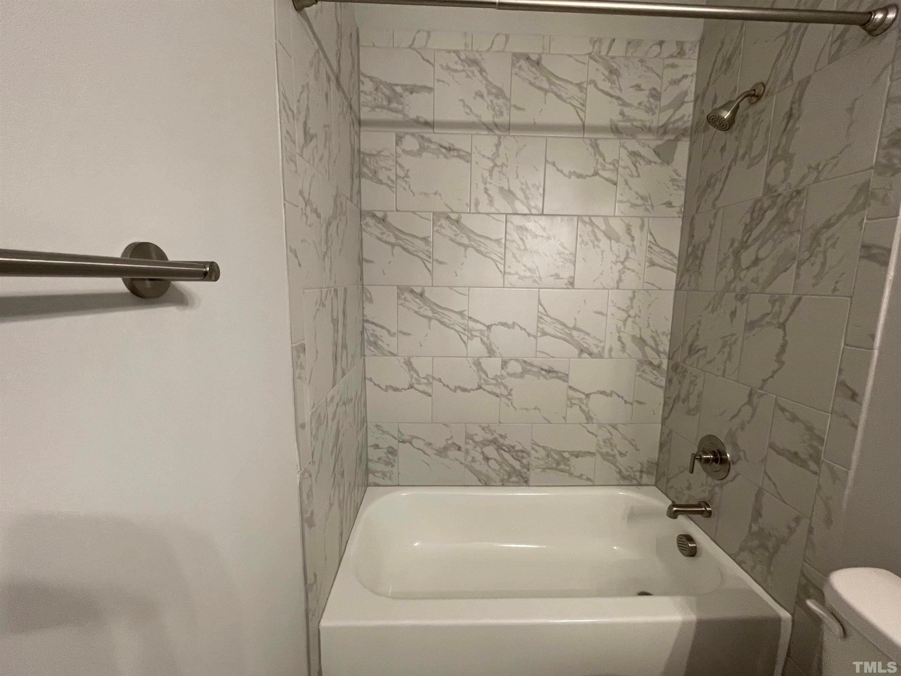 200 East Moore Street Apex, NC 27502 - Photo 28 of 32 a bathroom with a bathtub