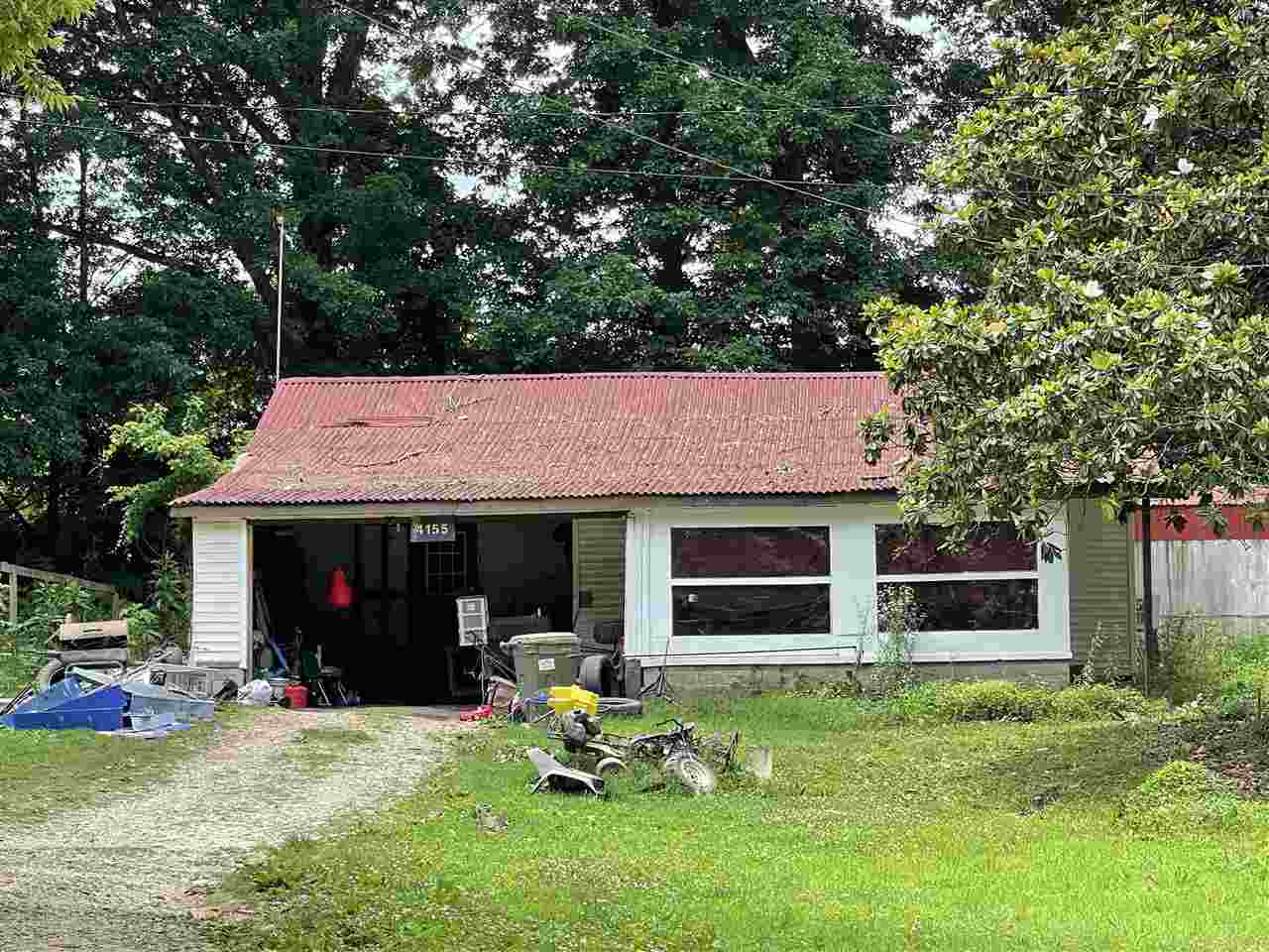 a view of a house with a yard and sitting area
