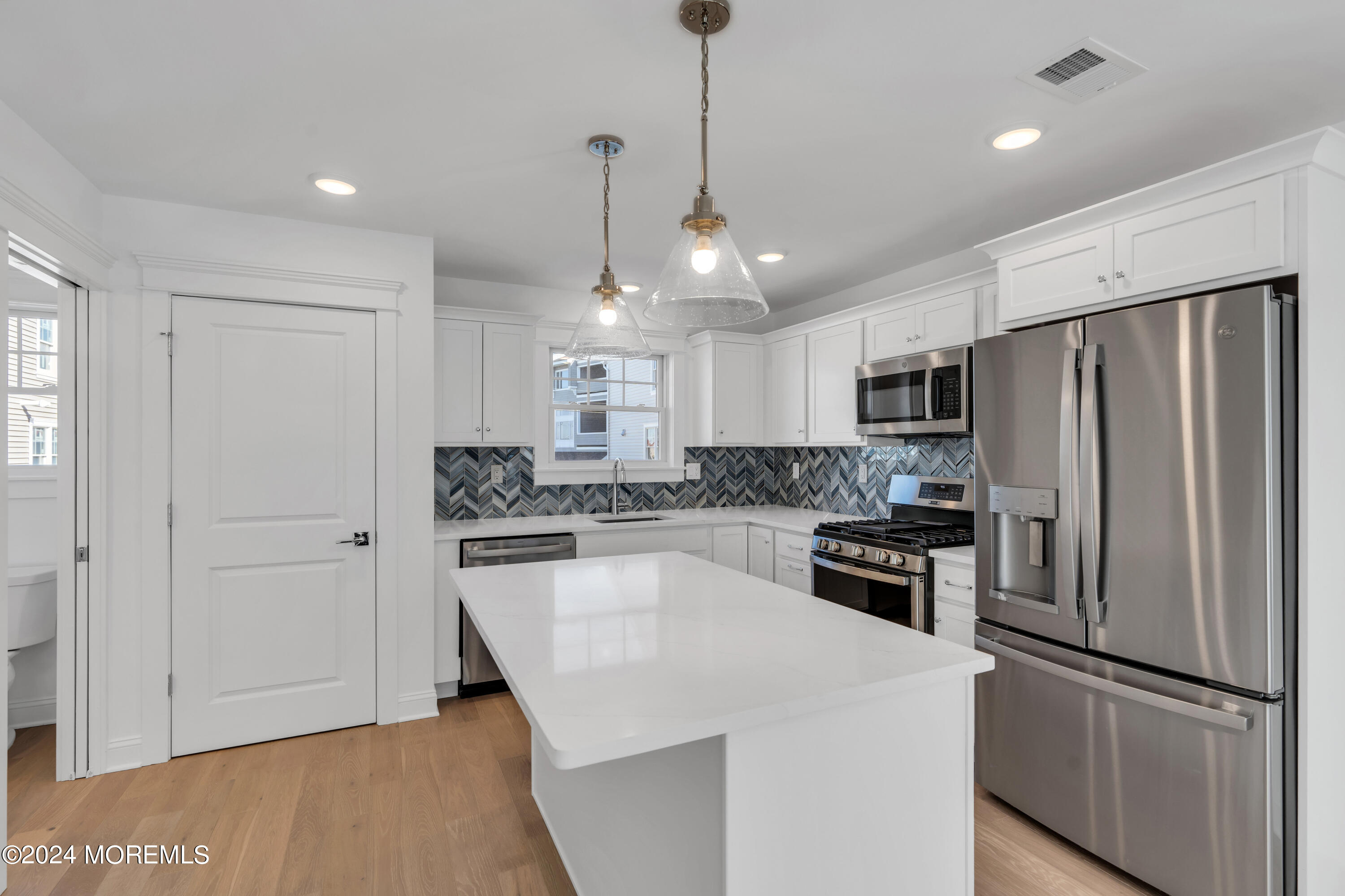 7 Shell Road, Unit 133 Mantoloking, NJ 08738 - Photo 14 of 44 a kitchen with stainless steel appliances a refrigerator sink and microwave