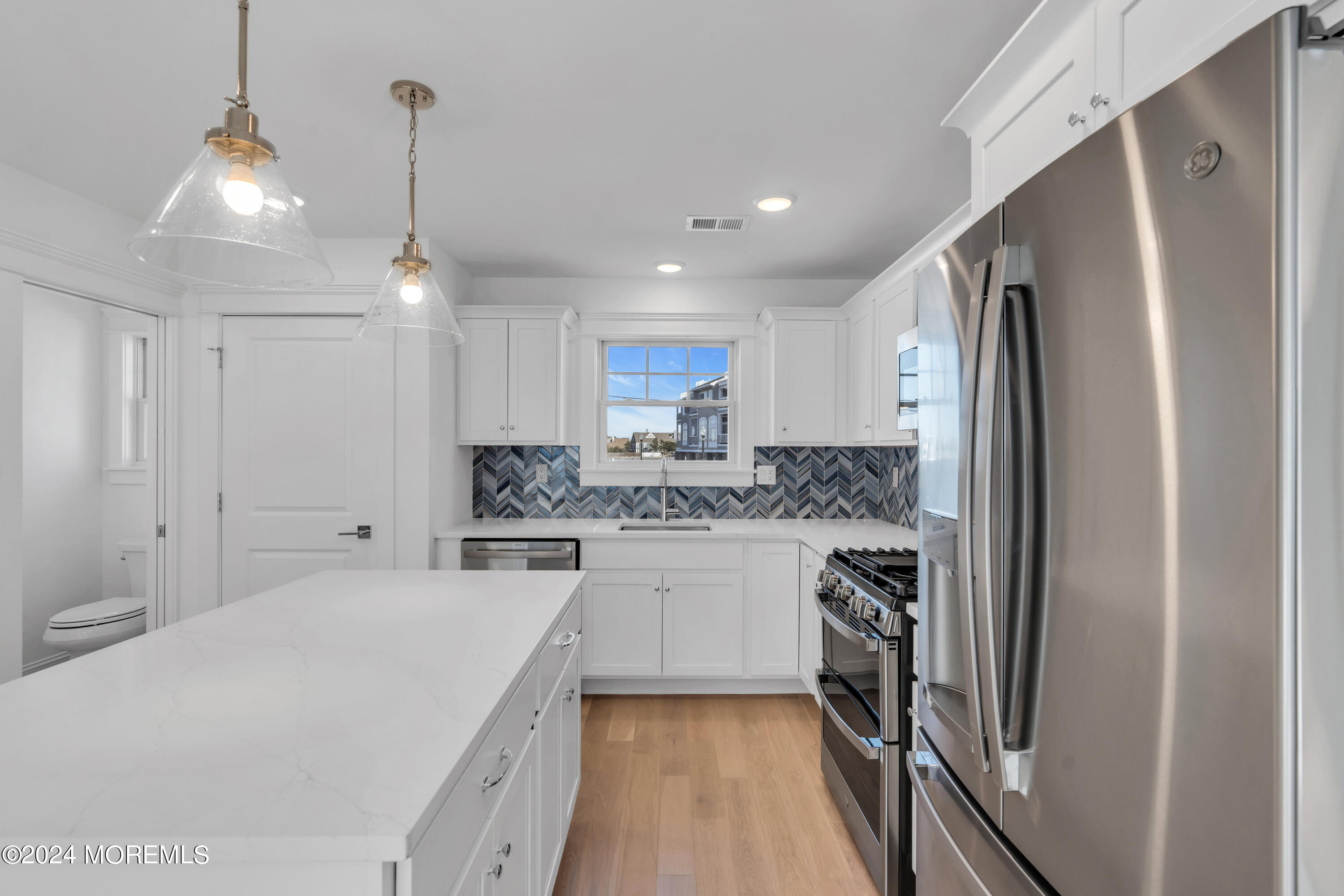 7 Shell Road, Unit 133 Mantoloking, NJ 08738 - Photo 15 of 44 a kitchen with a refrigerator sink and cabinets