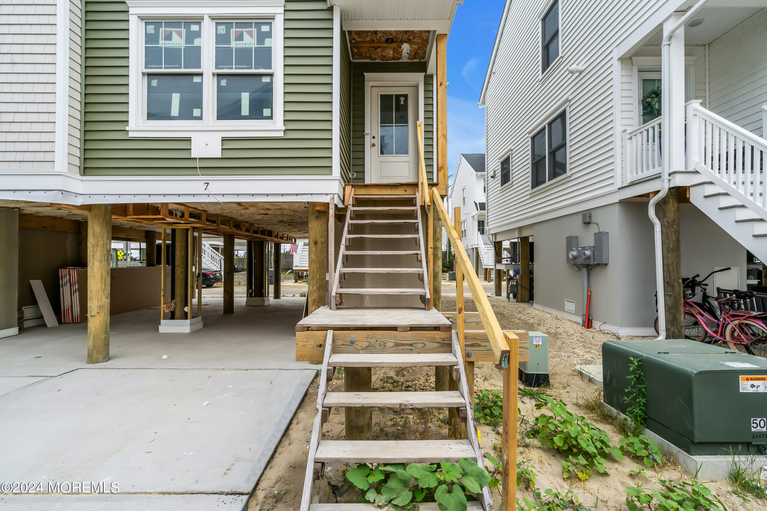 7 Shell Road, Unit 133 Mantoloking, NJ 08738 - Photo 2 of 44 a front view of a house with lots of trees around