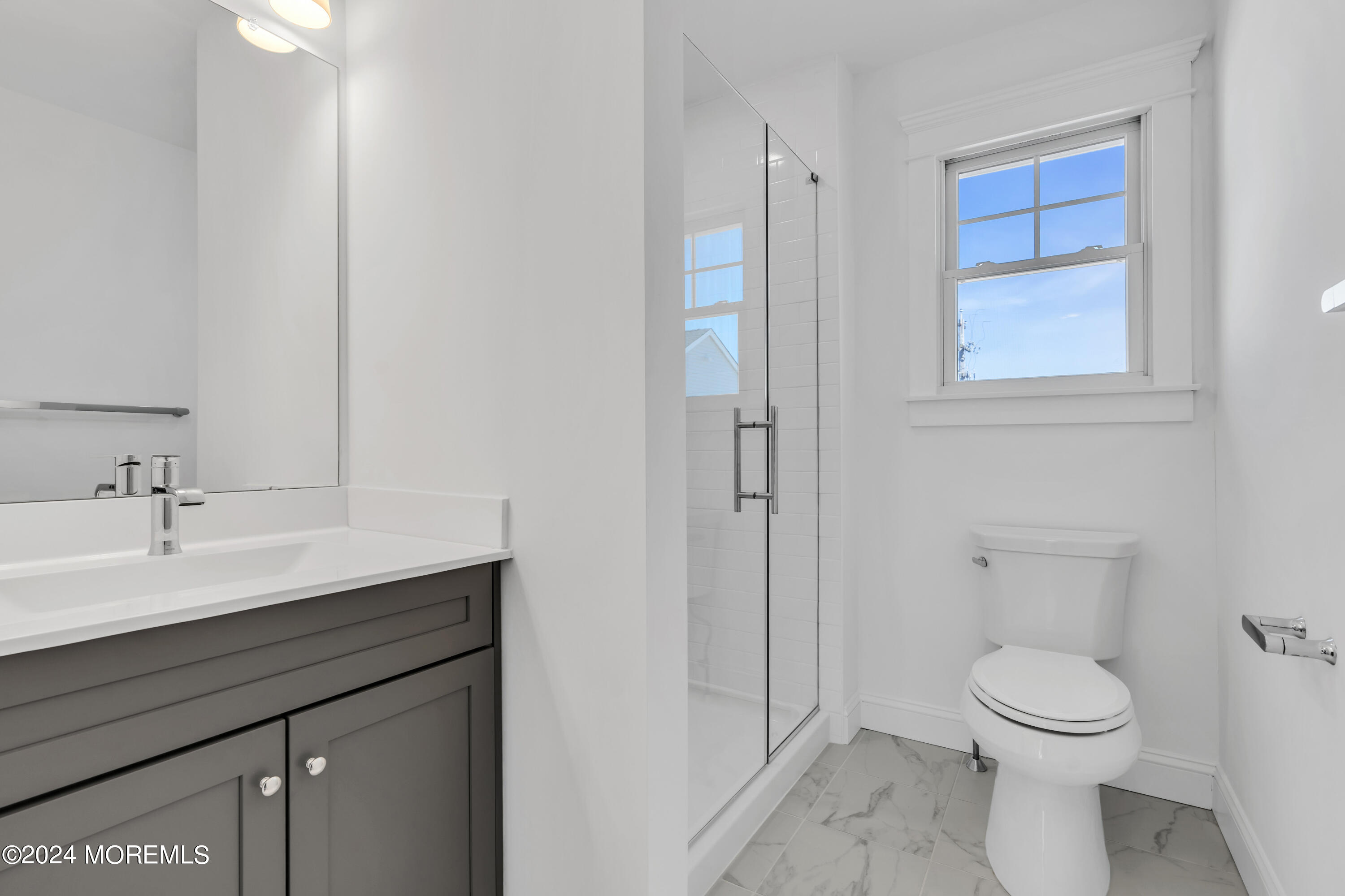 7 Shell Road, Unit 133 Mantoloking, NJ 08738 - Photo 29 of 44 a bathroom with a toilet a sink and mirror