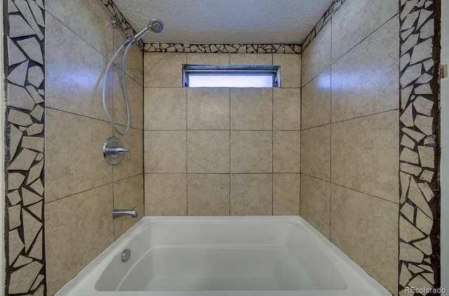 a bathroom with a bathtub and shower