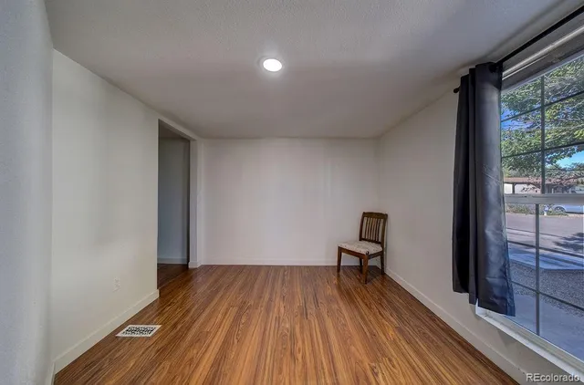 a view of a room with wooden floor and bench