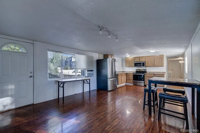 a view of kitchen with cabinets and wooden floor