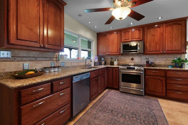 a kitchen with a refrigerator and a sink