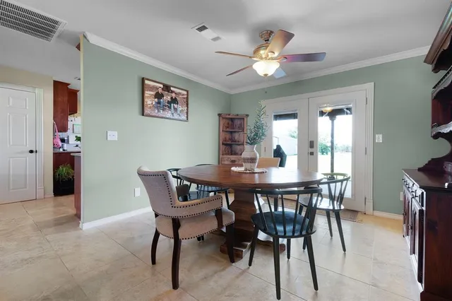 a kitchen with stainless steel appliances kitchen island granite countertop a refrigerator a stove and a sink with wooden floor