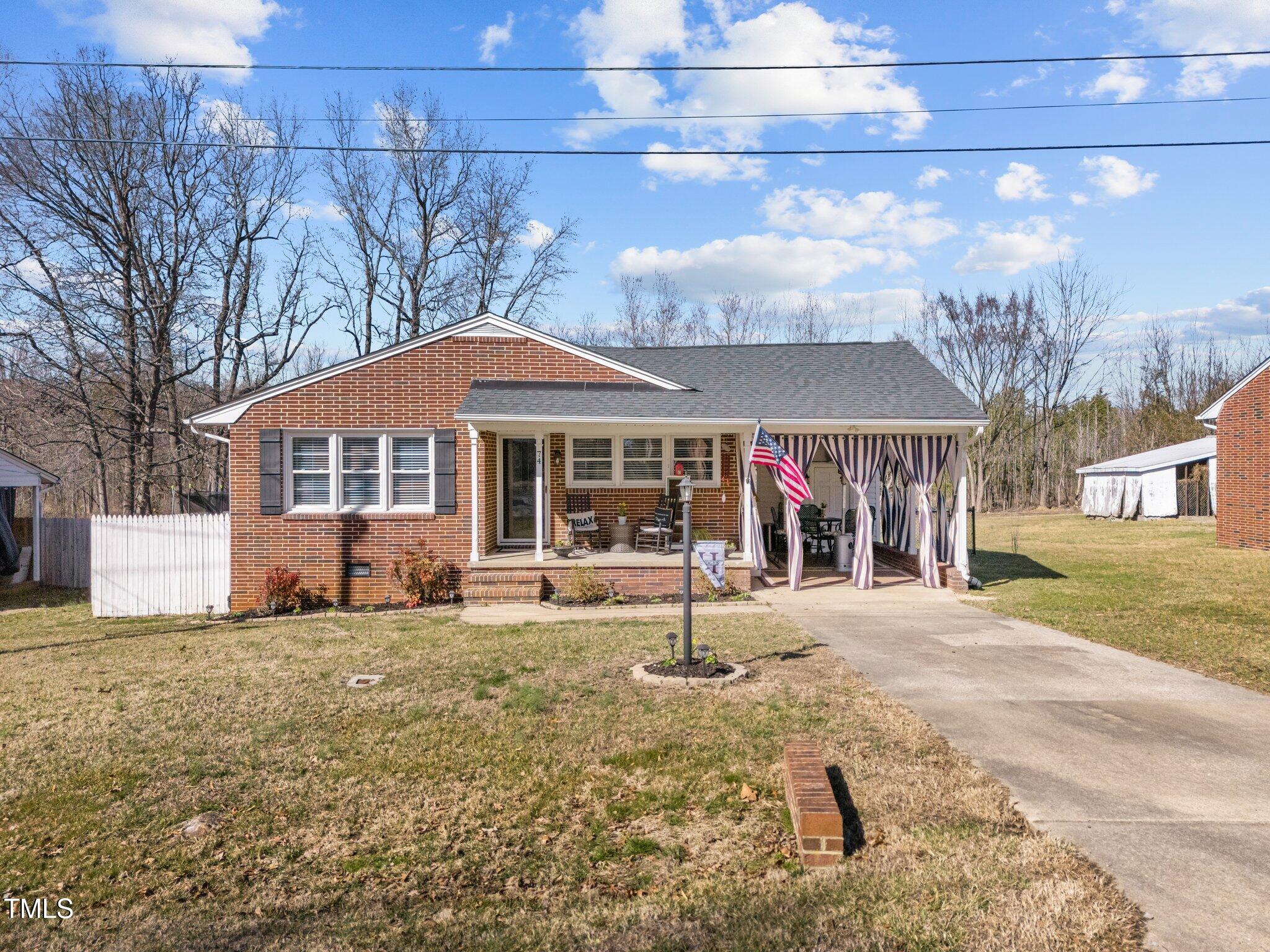 74 Azalea Drive Roxboro, NC 27573 - Photo 3 of 45 a front view of a house with a yard