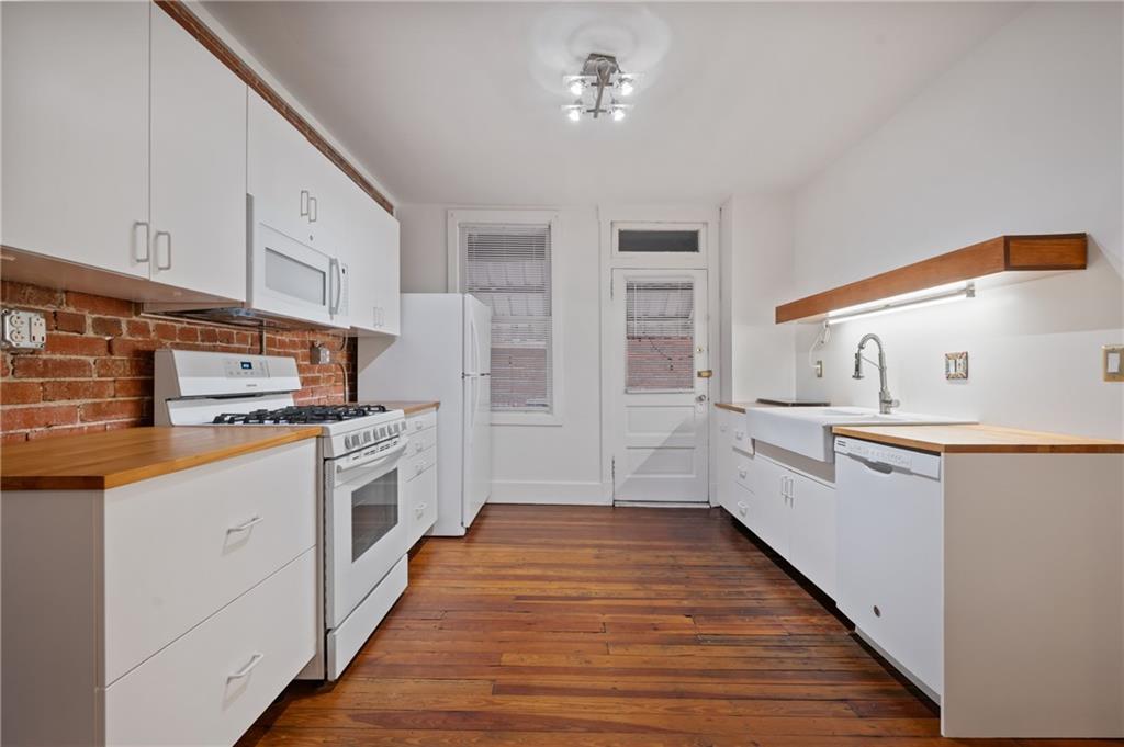368 44th Street Pittsburgh, PA 15201 - Photo 18 of 39 a kitchen with stainless steel appliances a white cabinets and wooden floor