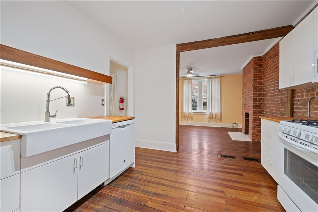 368 44th Street Pittsburgh, PA 15201 - Photo 20 of 39 a kitchen with a sink and wooden floors