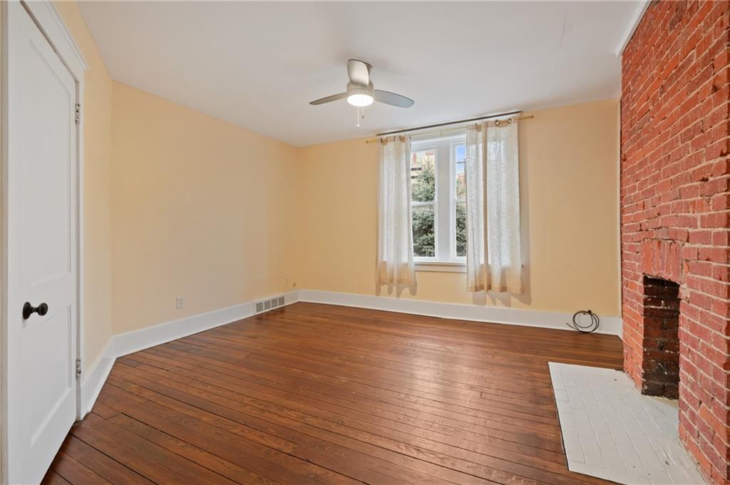368 44th Street Pittsburgh, PA 15201 - Photo 21 of 39 a view of an empty room with wooden floor and a window