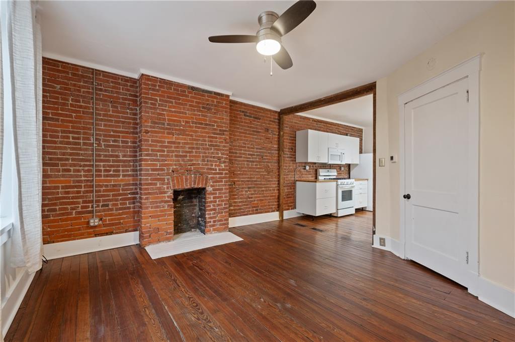 368 44th Street Pittsburgh, PA 15201 - Photo 22 of 39 a view of empty room with wooden floor and fireplace