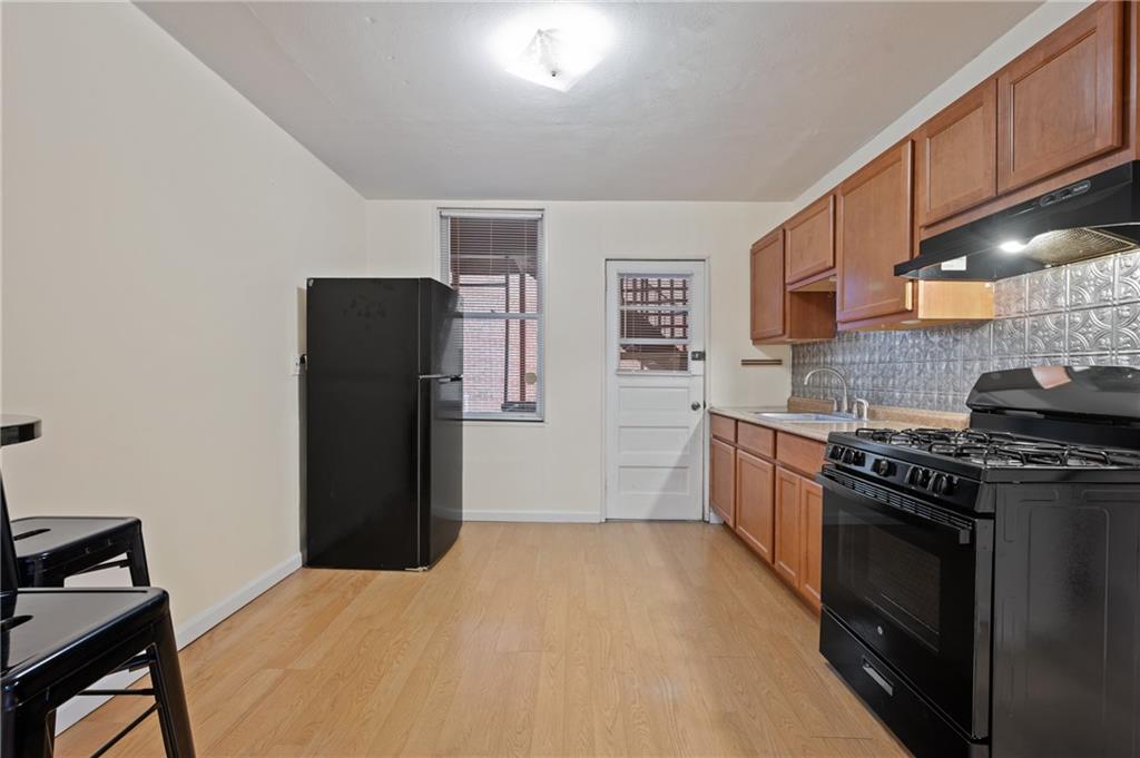368 44th Street Pittsburgh, PA 15201 - Photo 5 of 39 a kitchen with a refrigerator stove and sink