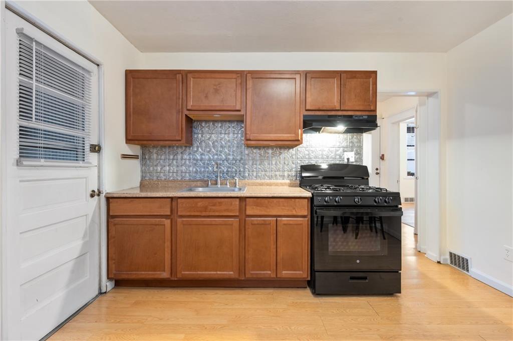 368 44th Street Pittsburgh, PA 15201 - Photo 6 of 39 a kitchen with stainless steel appliances granite countertop a stove a sink dishwasher and a refrigerator