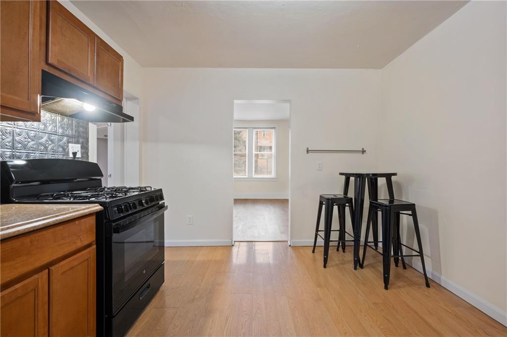 368 44th Street Pittsburgh, PA 15201 - Photo 7 of 39 a kitchen with granite countertop a stove and a refrigerator