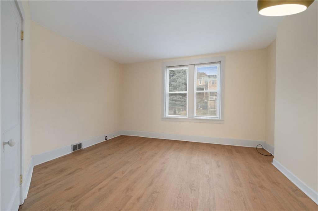 368 44th Street Pittsburgh, PA 15201 - Photo 9 of 39 an empty room with wooden floor and windows