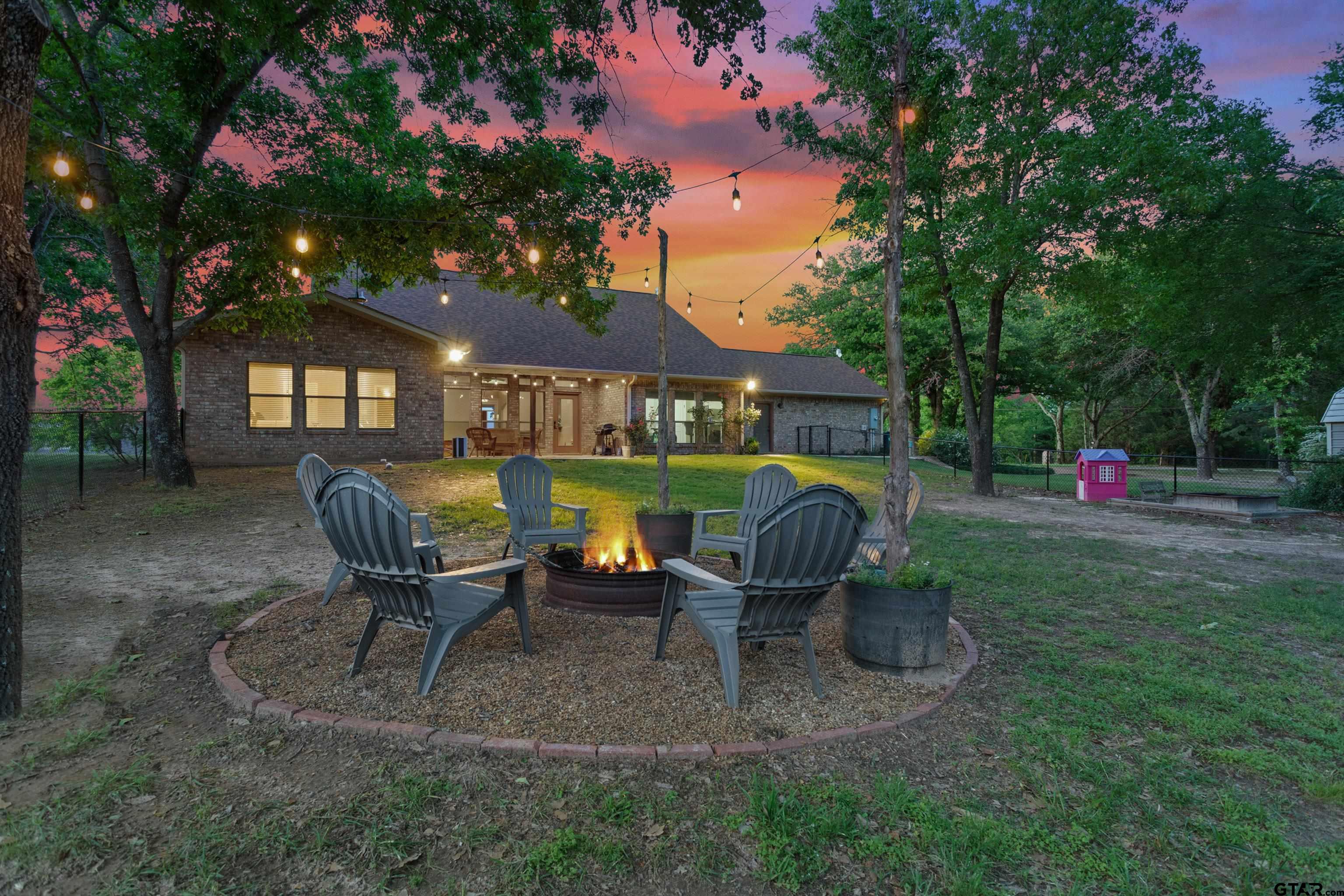 16551 Fox Run Lane Lindale, TX 75771 - Photo 30 of 41 a view of a chairs and table in backyard