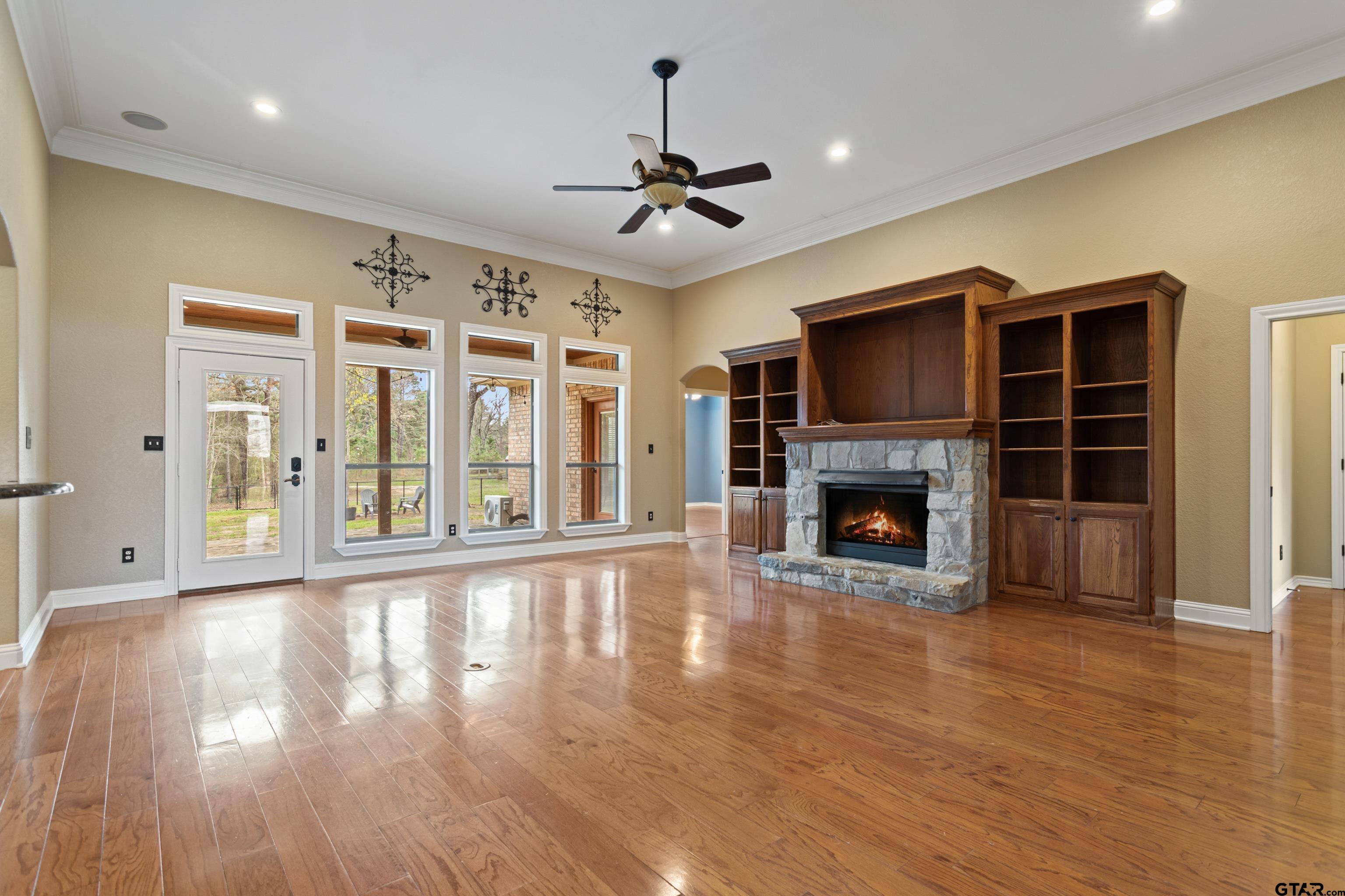 16551 Fox Run Lane Lindale, TX 75771 - Photo 3 of 41 a view of an empty room with wooden floor fireplace and a window