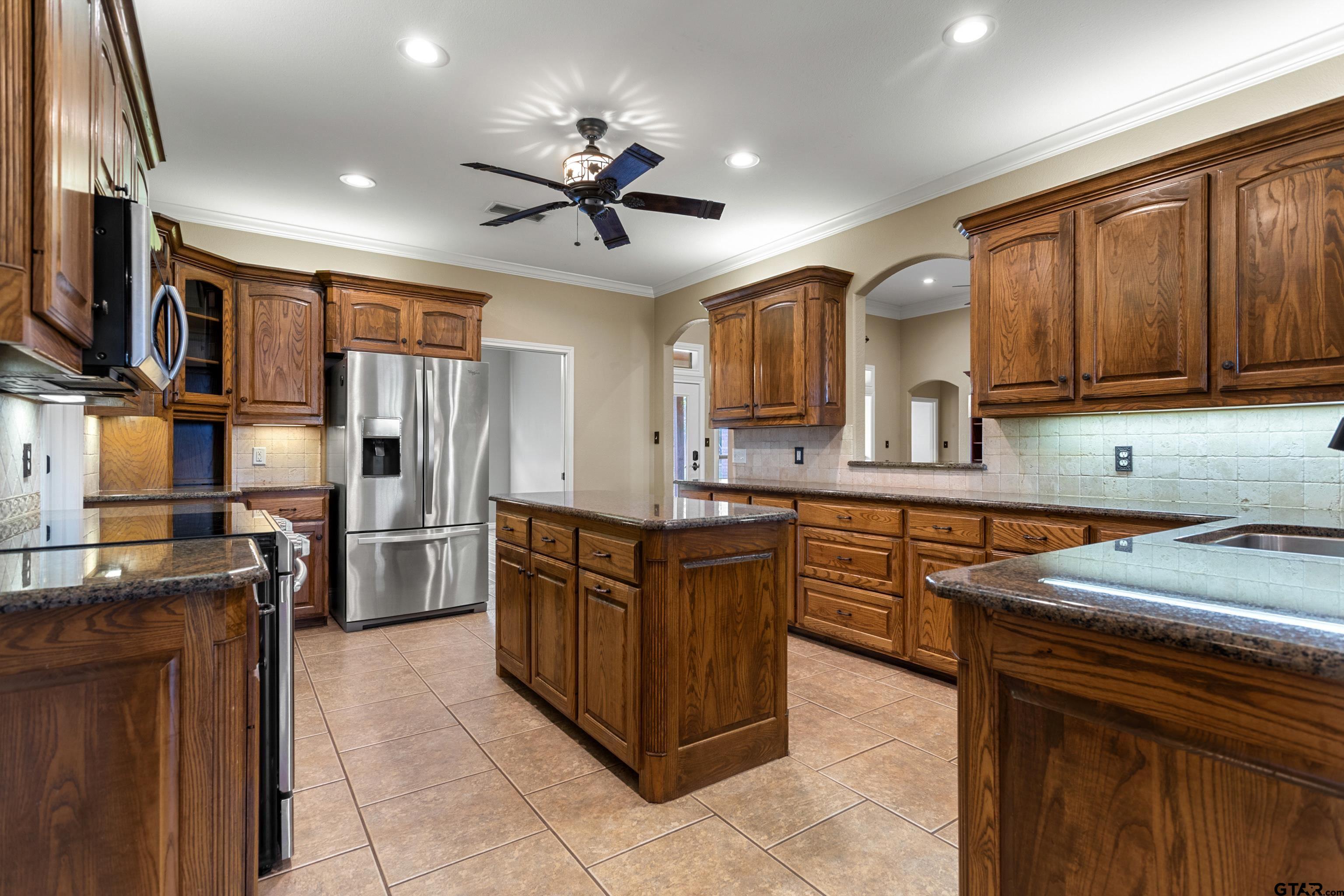 16551 Fox Run Lane Lindale, TX 75771 - Photo 7 of 41 a kitchen with stainless steel appliances granite countertop a sink stove and refrigerator