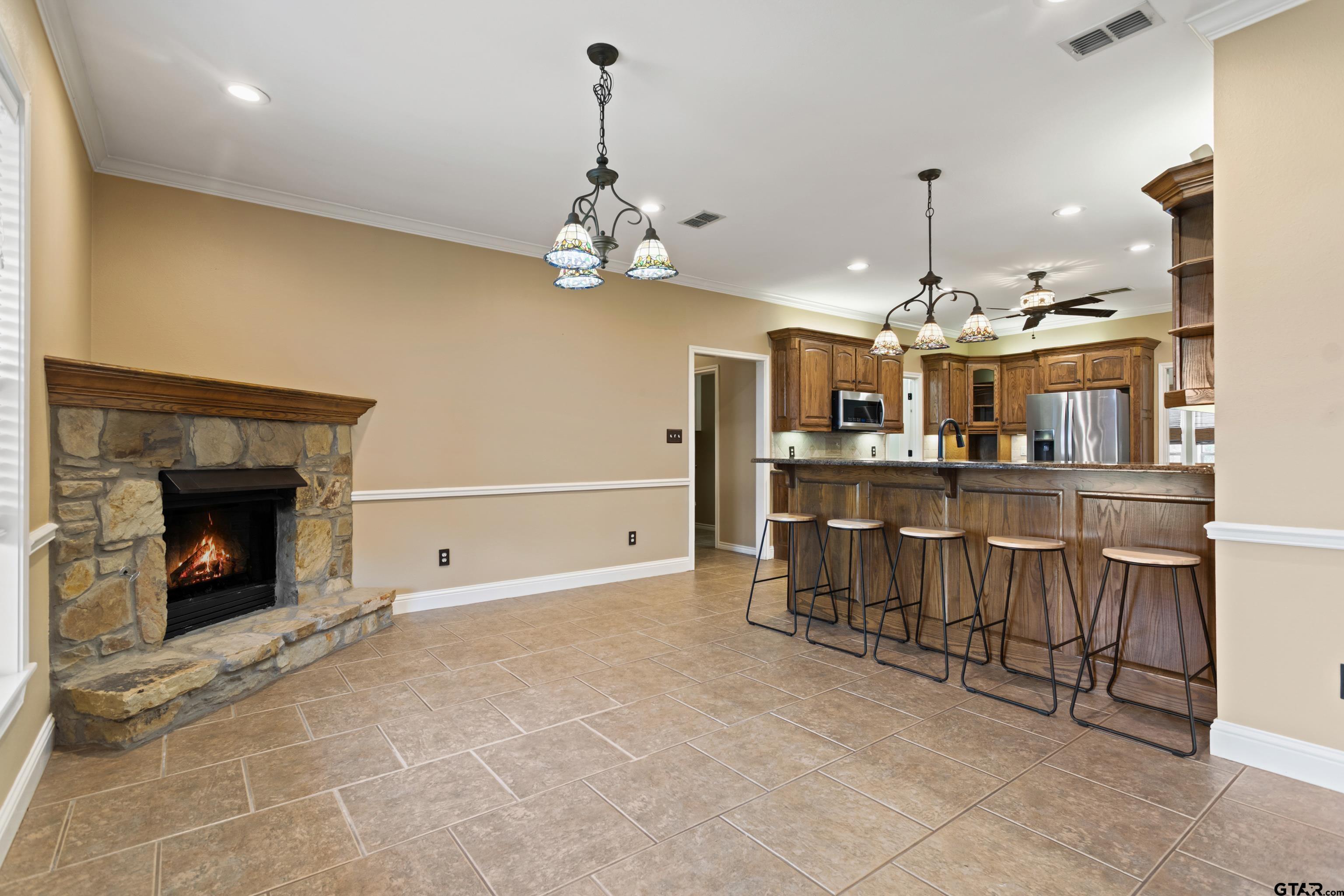 16551 Fox Run Lane Lindale, TX 75771 - Photo 10 of 41 a view of a kitchen with furniture and a fireplace