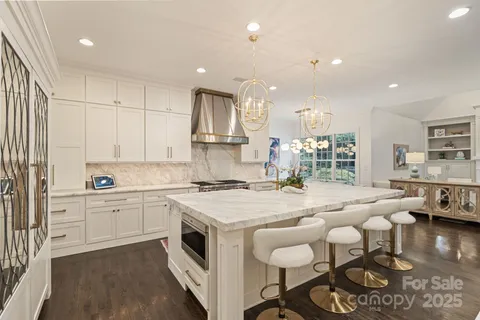 a kitchen with stove cabinets and chandelier