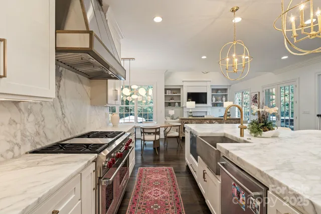 a kitchen with kitchen island granite countertop a stove and a sink