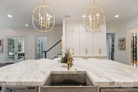 an open kitchen with a large counter top appliances and cabinets