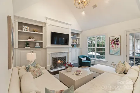 a living room with furniture and a view of kitchen