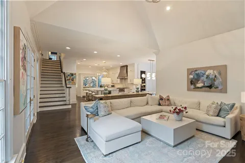 a living room with fireplace furniture and a large window