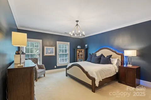 a bedroom with a bed and a television