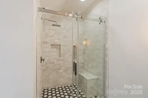 a bedroom with a bed mirror and window