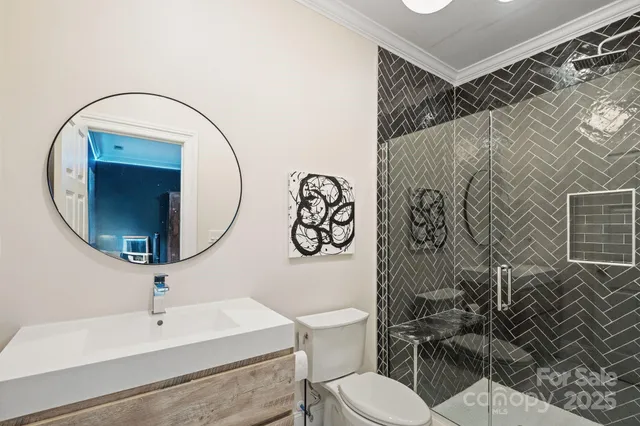 a bedroom with a bed and large windows