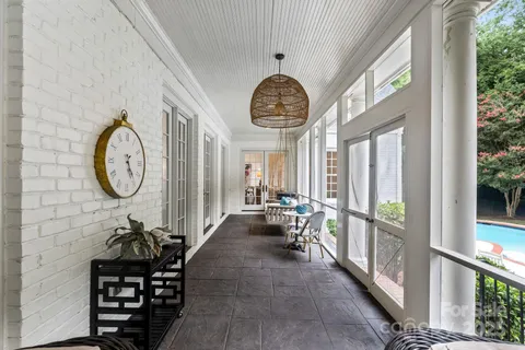 a view of a house with swimming pool and sitting area