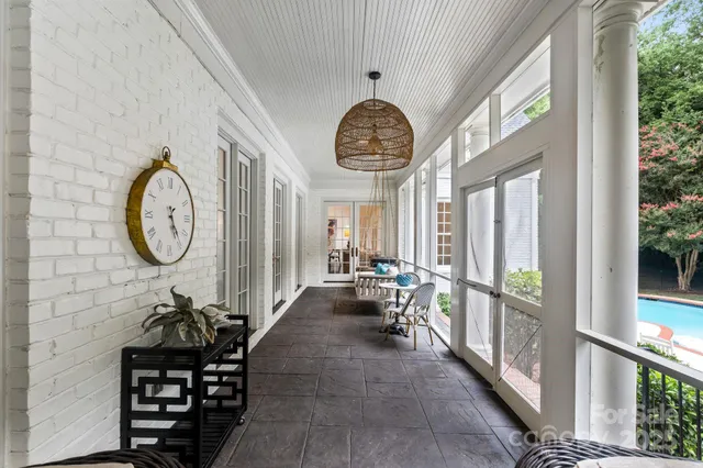 a view of a house with swimming pool and sitting area