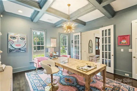 a living room with furniture a rug and a chandelier