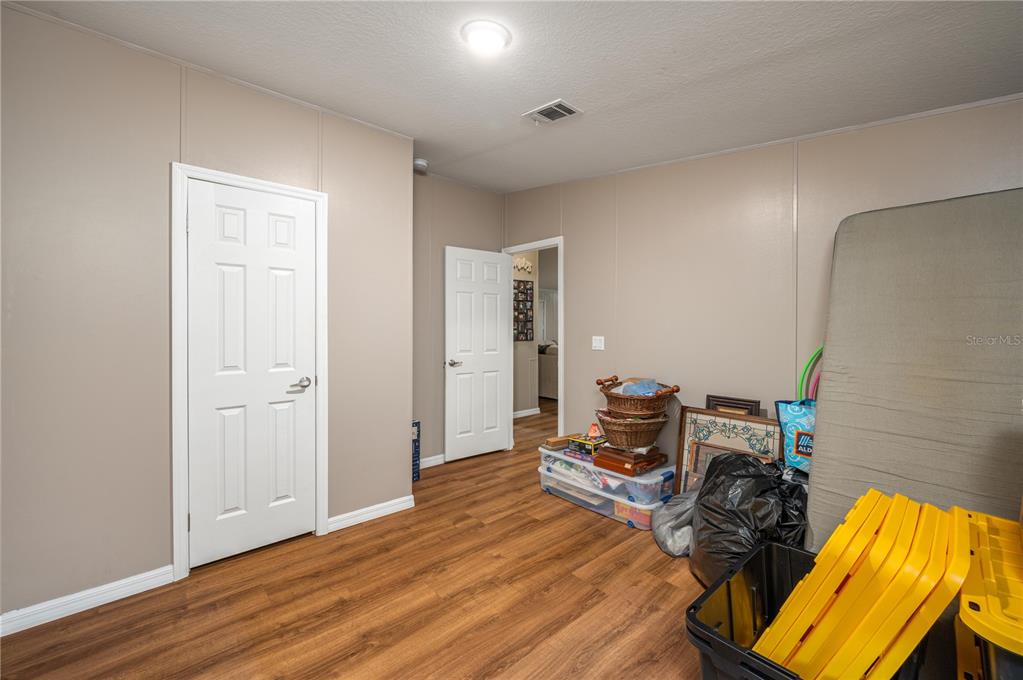 15079 Brahma Road Polk City, FL 33868 - Photo 23 of 40 a bedroom with a bed and wooden floor