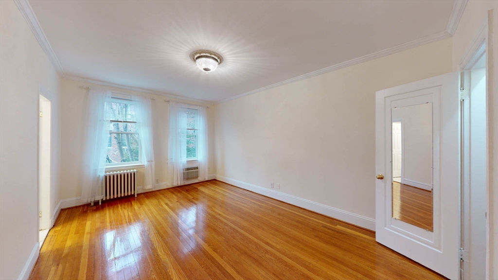 311 Tappan Street, Unit 3 Brookline, MA 02445 - Photo 28 of 35 an empty room with wooden floor and windows