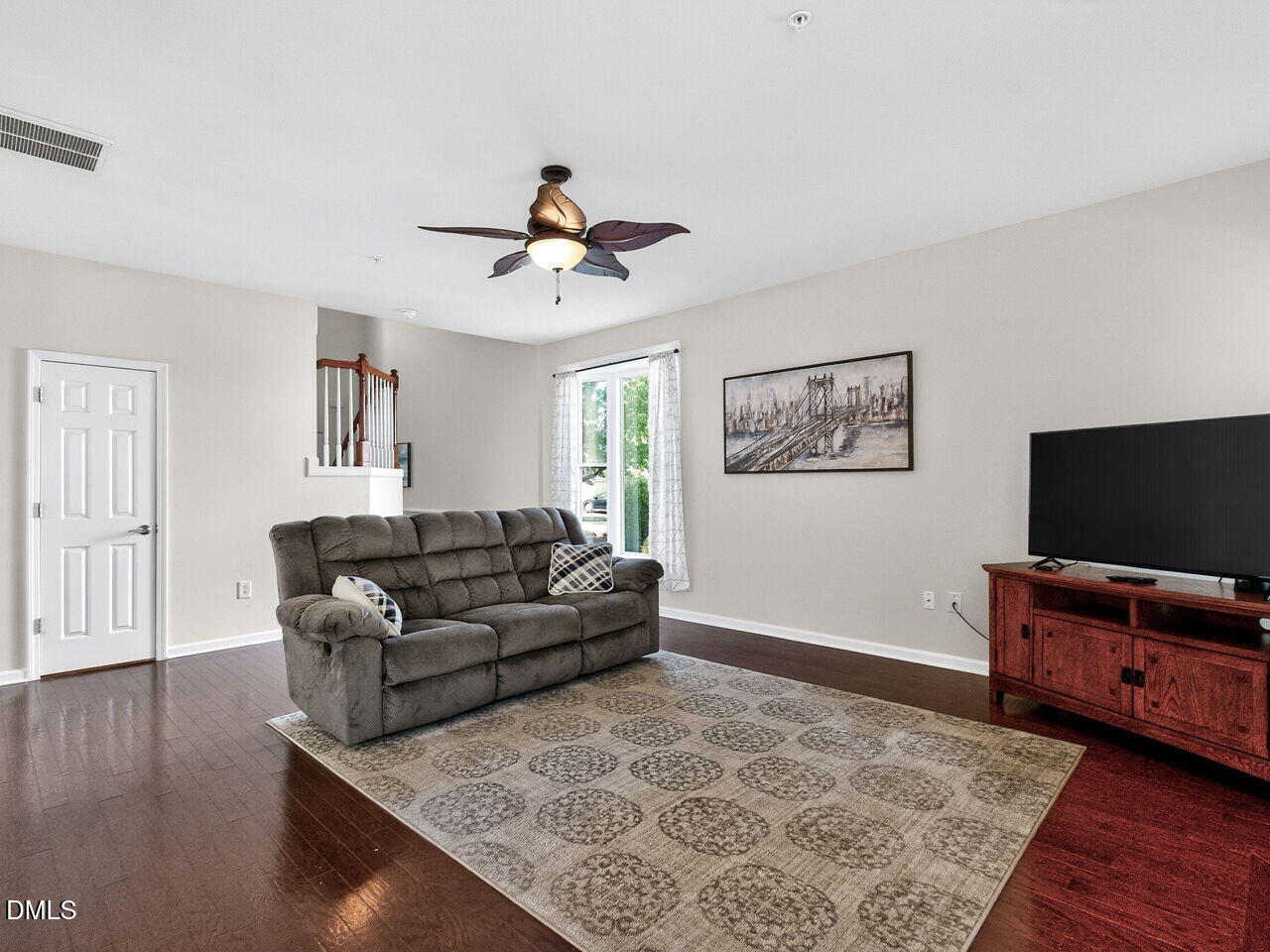 8215 Yaxley Hall Drive Raleigh, NC 27616 - Photo 9 of 42 a living room with furniture and a flat screen tv