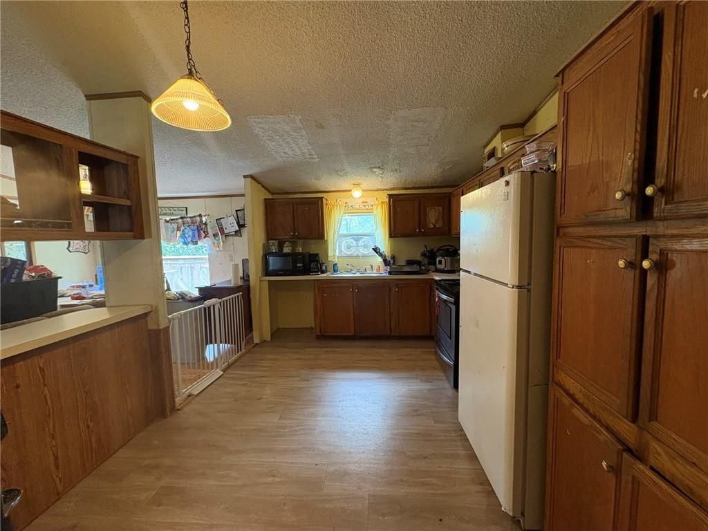 362 Hunters Lane Export, PA 15632 - Photo 8 of 17 a kitchen with refrigerator and a sink