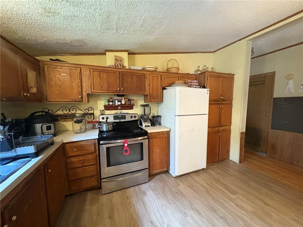 362 Hunters Lane Export, PA 15632 - Photo 9 of 17 a kitchen with a refrigerator a stove a sink and a microwave