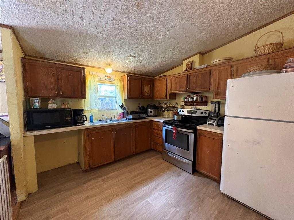 362 Hunters Lane Export, PA 15632 - Photo 10 of 17 a kitchen with stainless steel appliances granite countertop a refrigerator a stove a sink dishwasher and a refrigerator with wooden floor